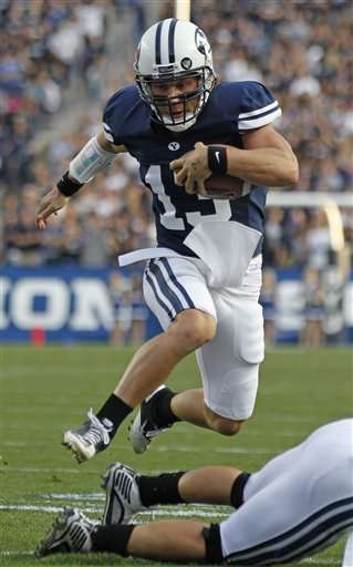 BYU quarterback Riley Nelson runs the ball against Utah State. (AP Photo/George Frey)