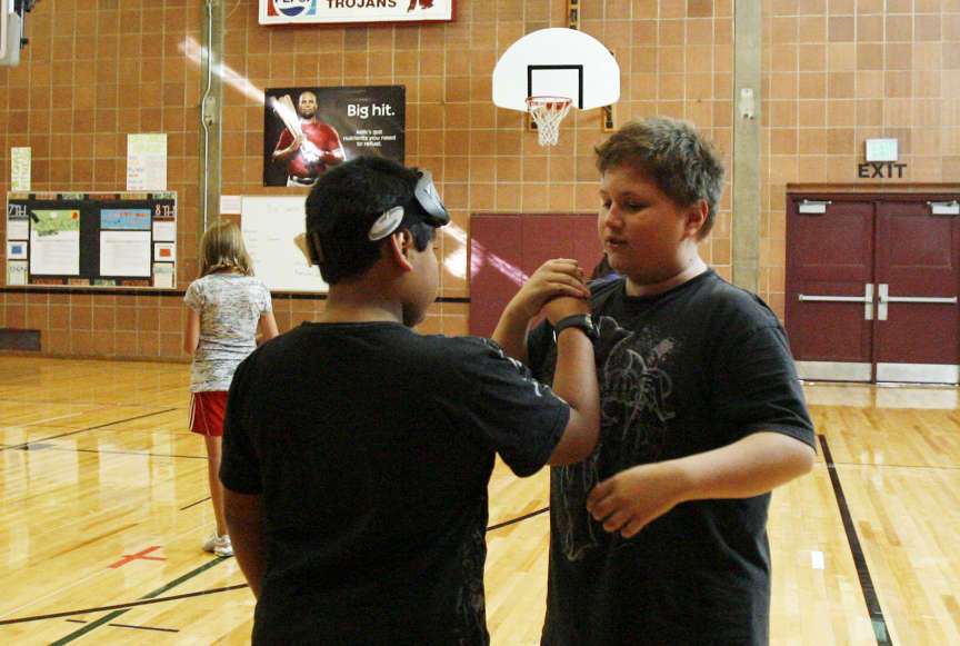 Sergio Arellano, left, and Cody Phelps greet each
other before Cody, who has a visual impairment,
teaches his classmates how to play goal ball at
Midvale Middle School Tuesday, Oct. 4, 2011.