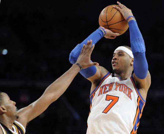 New York Knicks' Carmelo Anthony (7) puts up a shot against the Utah Jazz at Madison Square Garden. (AP Photo/Bill Kostroun)