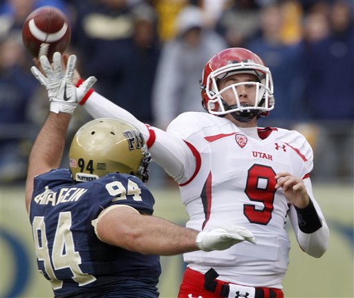 Utah QB Jon Hays gets off a pass under pressure by Pitt DT Myles Caragein. (AP Photo/Keith Srakocic)
