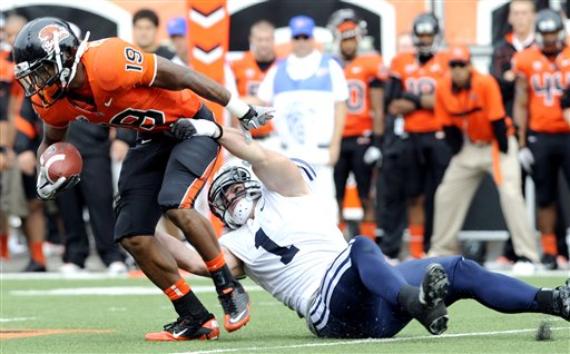 Oregon State's Jovan Stevenson tries to run against BYU's Jordan Pendleton. (AP Photo/Greg Wahl-Stephens)