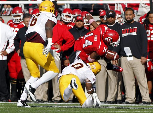 Utah wide receiver Reggie Dunn fumbles the ball 
in a tackle by Arizona State linebacker Shelly 
Lyons (6) and safety Clint Floyd (9). Arizona 
State won 35-14. (AP Photo/Jim Urquhart)