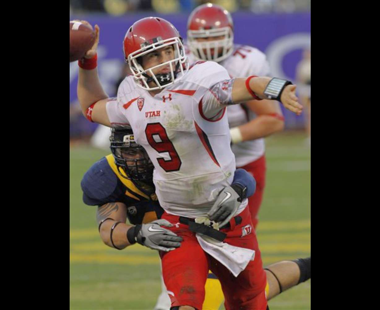 Utah quarterback Jon Hays throws under pressure
from a California player. (AP Photo/George
Nikitin)