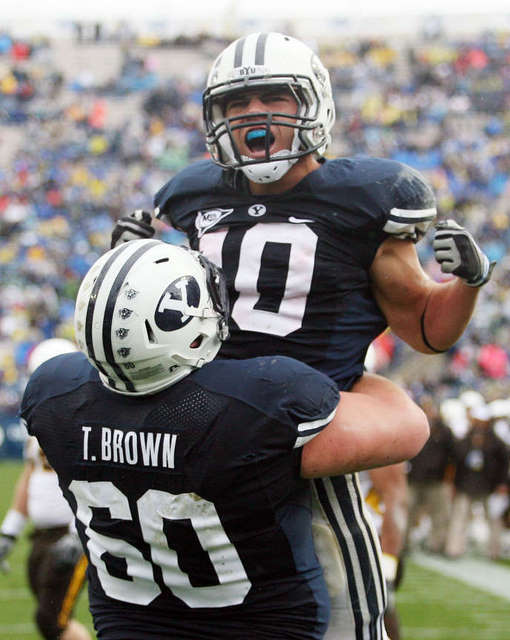 JJ Di Luigi of Brigham Young celebrates scoring 
the first touchdown with teammate Terence 
Brown. (Brian Nicholson, Deseret News)