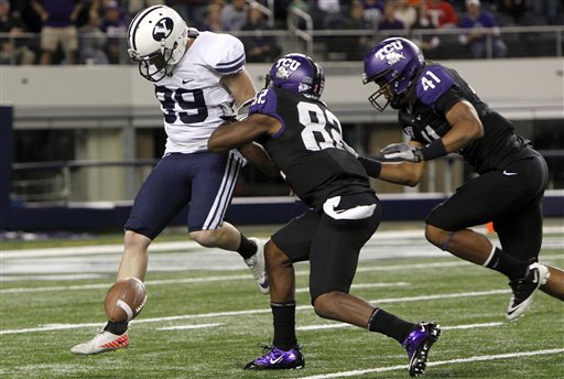 BYU kicker Riley Stephenson (99) tries to kick
the ball after missing the snap versus TCU. (AP
Photo/LM Otero)