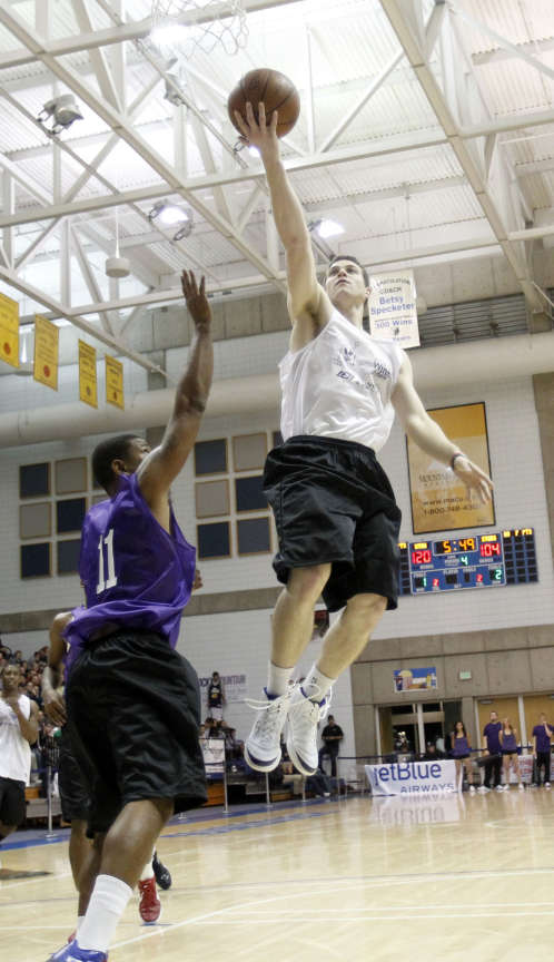 Jimmer Freddette drives the ball to the hoop over Earl Watson ,left, as members of the Utah Jazz and other NBA players play Monday, Nov. 7, 2011 at Salt Lake Community College's Bruin arena in Taylorsville Utah for Pro Players charity. (Scott G. Winterton, Deseret News)