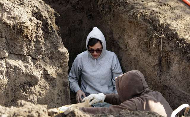 Utah Division of State History's Arie Leeflang and Debi Graham retrieve remains of a human skeleton in Salt Lake City on Tuesday, Nov. 8, 2011. A contractor working on a residential home remodel discovered the human remains believed to be nearly 1,000 years old.