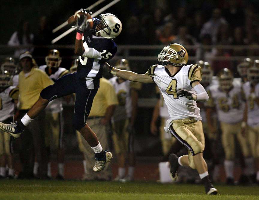 Syracuse's #15 Koa Mo'o intercepts a pass intended for Davis' 4 Karter Chisholm in the second half of the Davis High vs. Syracuse High at Syracuse High School on Friday, September 16, 2011. (Photo: Laura Seitz, Deseret News)