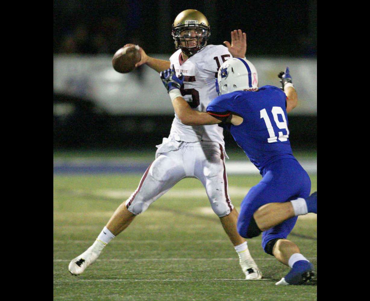 Lone Peak's Chase Hansen throws under pressure from Bingham's Drake Miller in Salt Lake County Thursday, Sept. 29, 2011. (Photo: Jeffrey D. Allred)