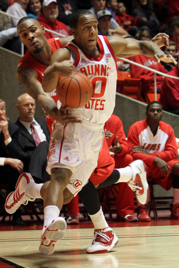 Chris Hines, at front, of the University of Utah, is fouled by A.J. Hardeman, of New Mexico as the University of Utah faces the University of New Mexico in Mountain West Conference basketball played in Salt Lake City, Utah Wednesday, Jan. 19, 2011. (Ravell Call, Deseret News)