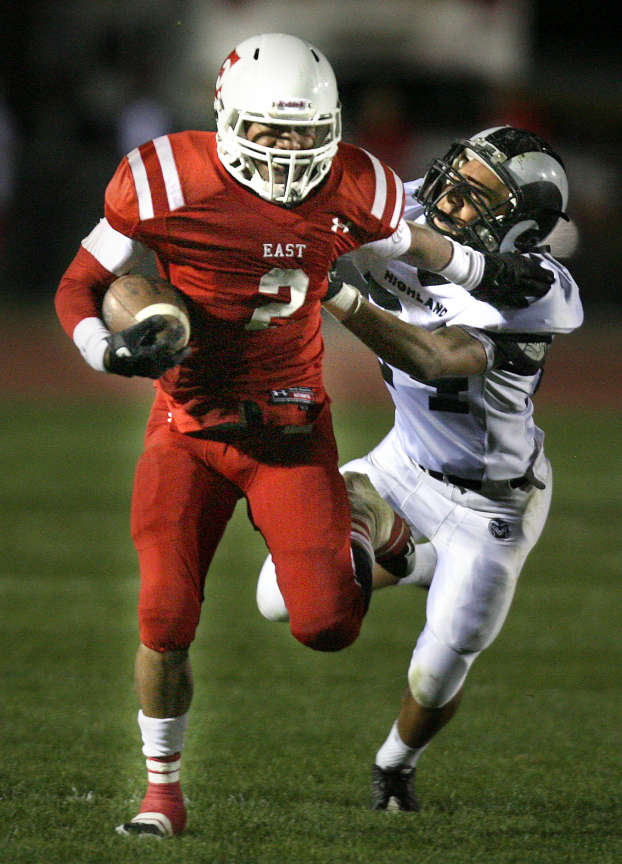 East's Liti Molisi gets past Highland's 24 Keish Easterwood in the Highland vs. East High School game at East High in Salt Lake City on Friday, October 13, 2011. (Laura Seitz, Deseret News)