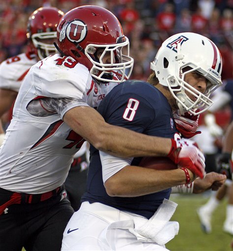 Arizona quarterback Nick Foles is sacked for a
loss by Utah's Trevor Reilly. (AP Photo/Wily
Low)