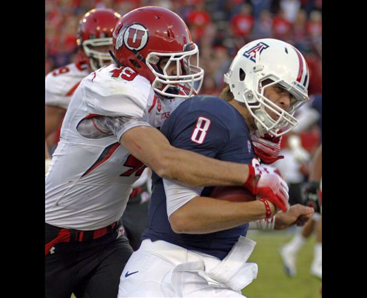 Arizona quarterback Nick Foles is sacked for a
loss by Utah's Trevor Reilly. (AP Photo/Wily
Low)