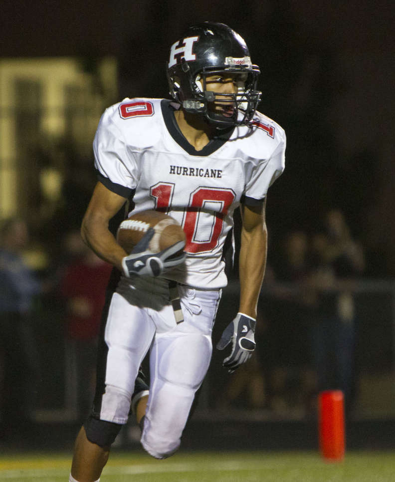 Hurricane's Adam Thompson carries the ball in the second half during the Tigers' 35-8 win over Desert Hills Thursday, Oct. 13, 2011. The win guarantees the Tigers as the No. 1 seed from Region 9 for the 3A state playoffs. (Samantha Clemens, The Spectrum)