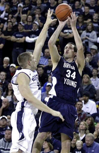 BYU forward Noah Hartsock shoots over Utah 
State forward Morgan Grim. (AP Photo/Jim 
Urquhart)