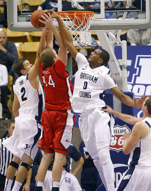BYU's Brandon Davies ,right, teammate Craig 
Cusick ,left, team up to block the shot by BYU-
Hawaii's Brady Hurst. (Deseret News)