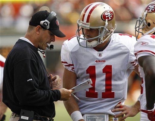 San Francisco 49ers head coach Jim Harbaugh, 
left, talks with quarterback Alex Smith. (AP 
Photo/Ed Reinke)