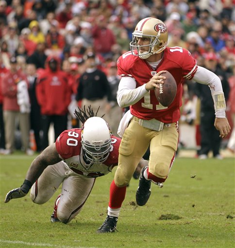 San Francisco 49ers quarterback Alex Smith (11) 
scrambles as Arizona Cardinals defensive end 
Darnell Dockett (90) reaches for him. (AP 
Photo/Ben Margot)