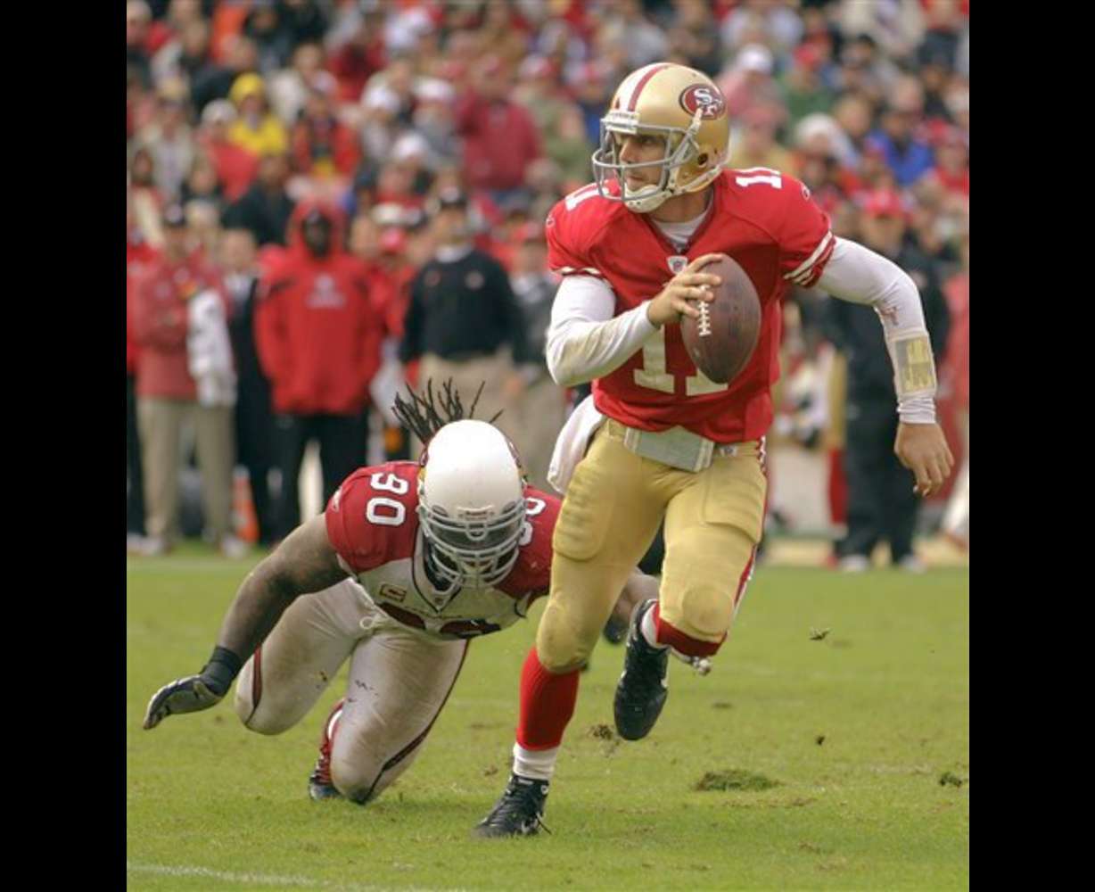 San Francisco 49ers quarterback Alex Smith (11)
scrambles as Arizona Cardinals defensive end
Darnell Dockett (90) reaches for him. (AP
Photo/Ben Margot)