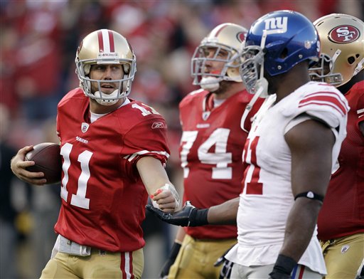 San Francisco 49ers quarterback Alex Smith 
slaps hands with New York Giants defensive end 
Justin Tuck. (AP Photo/Ben Margot)