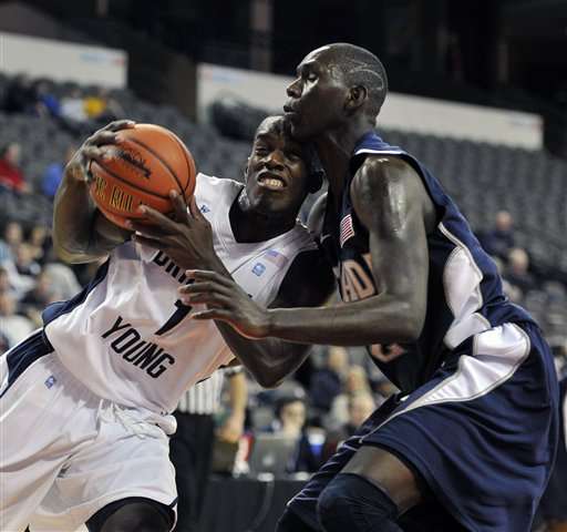 BYU's Charles Abouo (1) drives to the basket
against Nevada's Jerry Evans. (AP Photo/Jim
Prisching)