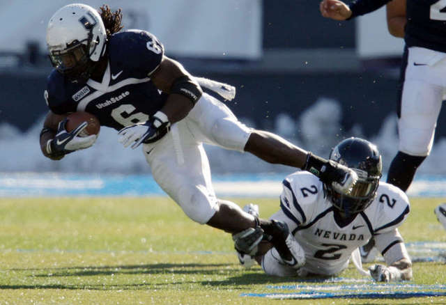Utah State Aggies running back Robert Turbin
(6) runs against Nevada. USU beat Nevada and is
now bowl eligible. (Deseret News)