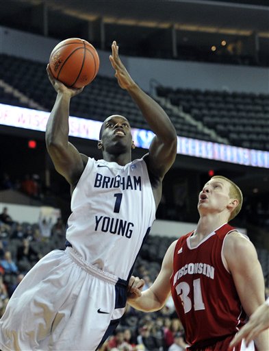 BYU's Charles Abouo (1) drives to the basket 
against Wisconsin's Mike Bruesewitz. (AP 
Photo/Jim Prisching)