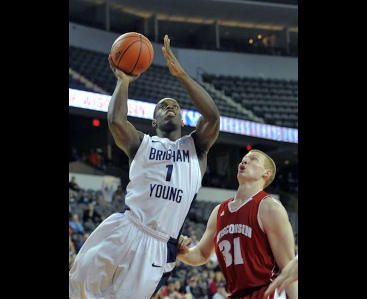 BYU's Charles Abouo (1) drives to the basket
against Wisconsin's Mike Bruesewitz. (AP
Photo/Jim Prisching)