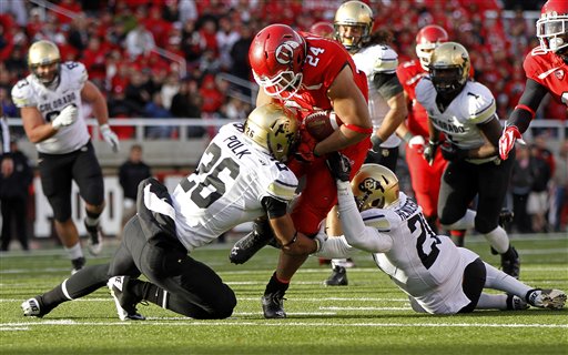 Utah running back Tauni Vakapuna (24) is 
tackled by Colorado defensive backs Ray Polk 
(26) and Greg Henderson (20. Colorado won 17-
14. (AP Photo/Jim Urquhart)
