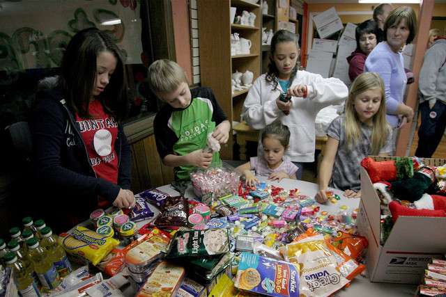 A group of Uintah County children fill Christmas stockings Monday, Nov. 28, 2011, that are being sent to members of a Marine Corps platoon in Afghanistan. The platoon was adopted by people from throughout the United States as part of a project launched by a group of Vernal women. (Photo: Geoff Liesik, Deseret News)