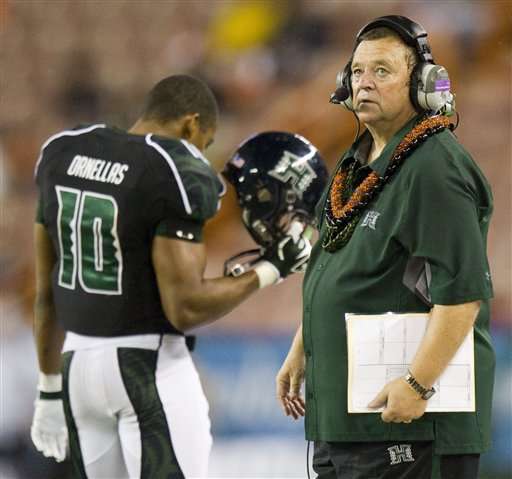 Hawaii head coach Greg McMackin glances at the
score board against Tulane. (AP Photo/Eugene
Tanner)