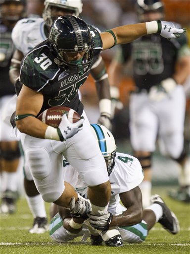 Hawaii running back Joey Iosefa (30) is tackled 
from behind by Tulane safety Shakiel Smith. (AP 
Photo/Eugene Tanner)