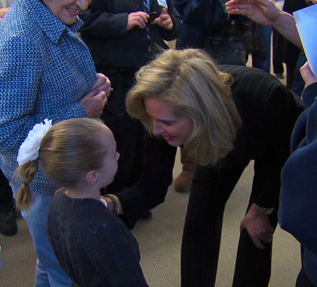 Ann Romney bent down to accept a drawing from 
6-year-old Kyla Nielsen during a tour of her 
husband's Utah presidential campaign 
headquarters Friday that capped off a day of 
fundraising.