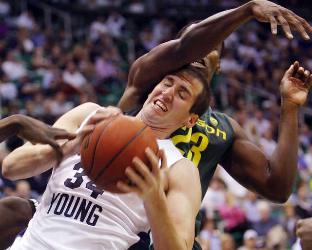 BYU's Noah Hartsock is fouled by Oregon's
Jeremy Jacob. (Deseret News)