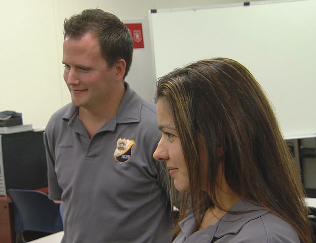 Salt Lake City police evidence technicians Zacharia Carlsson and Haley Takoch look on as Ralph Moore looks at his fathers slides they recovered for him.