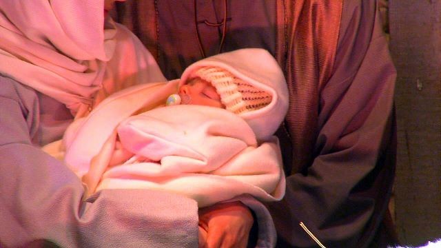 Mary and Joseph even watch over a live baby Jesus, bundled up in the warmest of swaddling clothes.
