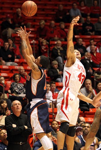 Cal State Fullerton coach Bob Burton, left,
watches as guard Isiah Umipig (13) and Utah
guard Cedric Martin (43) go after a rebound.
(AP Photo/Colin E Braley)
