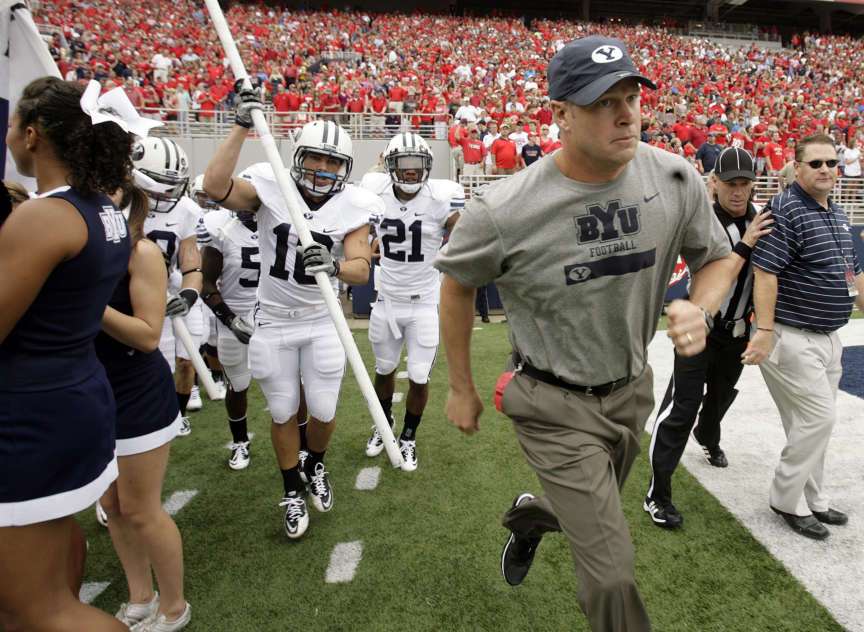 BYU head coach Bronco Mendenhall leads his team
onto the field.