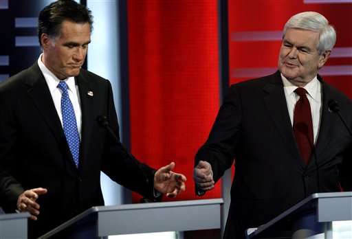 Republican presidential candidates Mitt Romney, left, and Newt Gingrich, right, during the Republican debate, Saturday, Dec. 10, 2011, in Des Moines, Iowa. (AP Photo/Charlie Neibergall)
