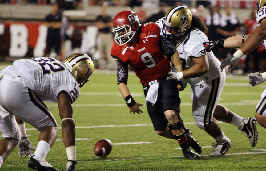 Utah Utes quarterback Jon Hays (9) fumbles the ball under pressure form Washington Huskies defensive tackle Lawrence Lagafuaina (97) during NCAA football action in Salt Lake City Saturday, Oct. 1, 2011. (Jeffrey D. Allred, Deseret News)