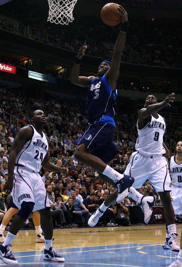 Dallas Mavericks guard Josh Howard (5) gets past Utah Jazz guard Ronnie Brewer (9) and over Utah Jazz forward Paul Millsap (24) for a basket as the Utah Jazz host the Dallas Mavericks at Energy Solutions Arena in Salt Lake City on Thursday, Feb. 5, 2009. (Mike Terry, Deseret News)