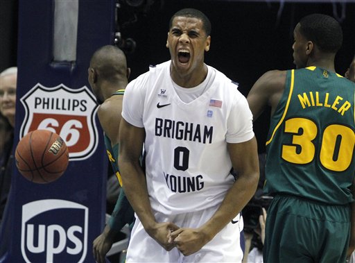 BYU forward Brandon Davies (0) reacts after a 
dunk over Baylor forwards Cory Jefferson, left, 
and Quincy Miller (30). (AP Photo/Jim Urquhart)
