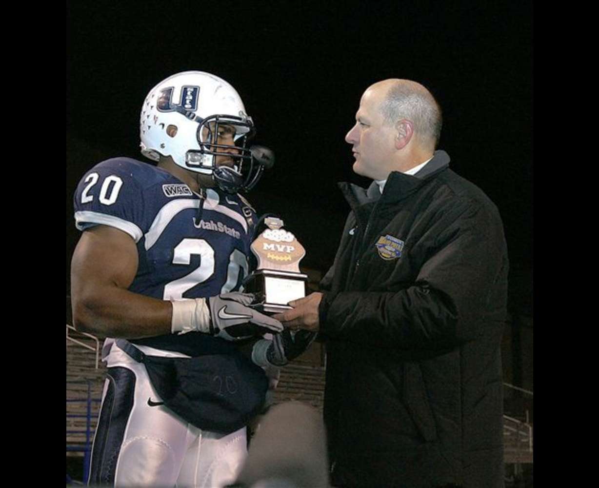 USU running back Michael Smith accepts the Famous Idaho Potato Bowl Most Valuable Player trophy for Utah State University.
