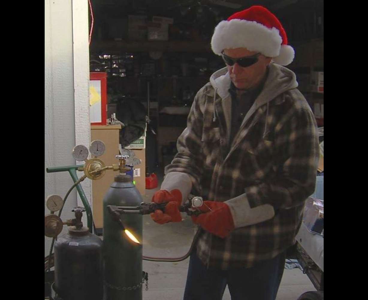 Steve Fidel pulls out the heavy artillery — a cutting torch — in his attempt to find the best way to open clamshell packaging.