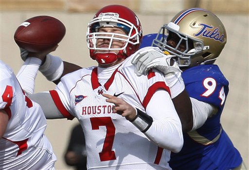 Houston quarterback Case Keenum (7) is hit by
Tulsa defensive end Tyrunn Walker. (AP
Photo/Sue Ogrocki)