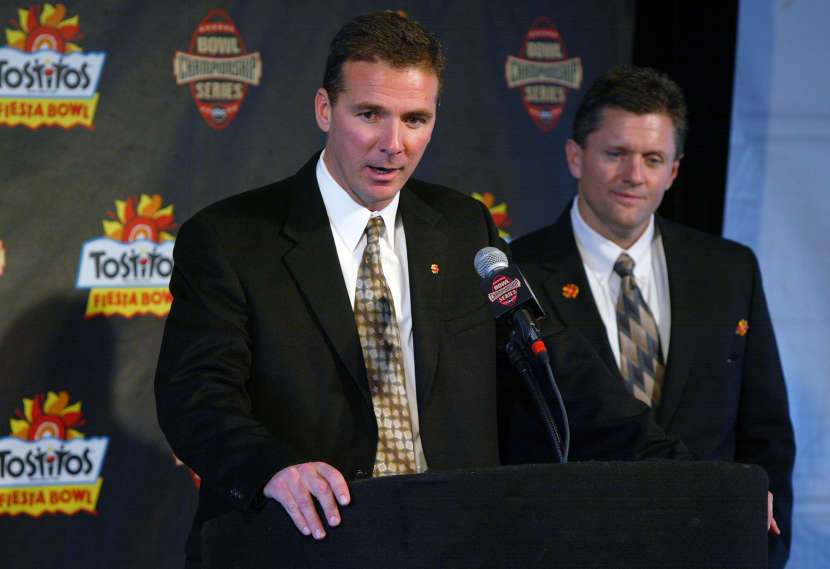 University of Utah football co-coaches Kyle Whittingham and Urban Meyer (L) speak to the media Dec 26th, 2004 at the airport in Phoenix, Arizona upon their arrival for the Fiesta Bowl. (Jeffrey D. Allred, Deseret News)
