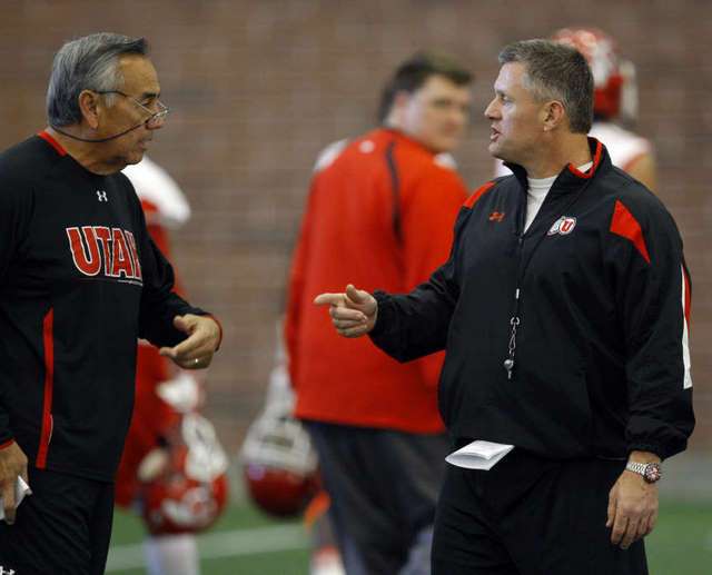 Utah Head Coach Kyle Whittingham ,right, and
Offensive Coordinator Norm Chow talk during
practice. (Deseret News)