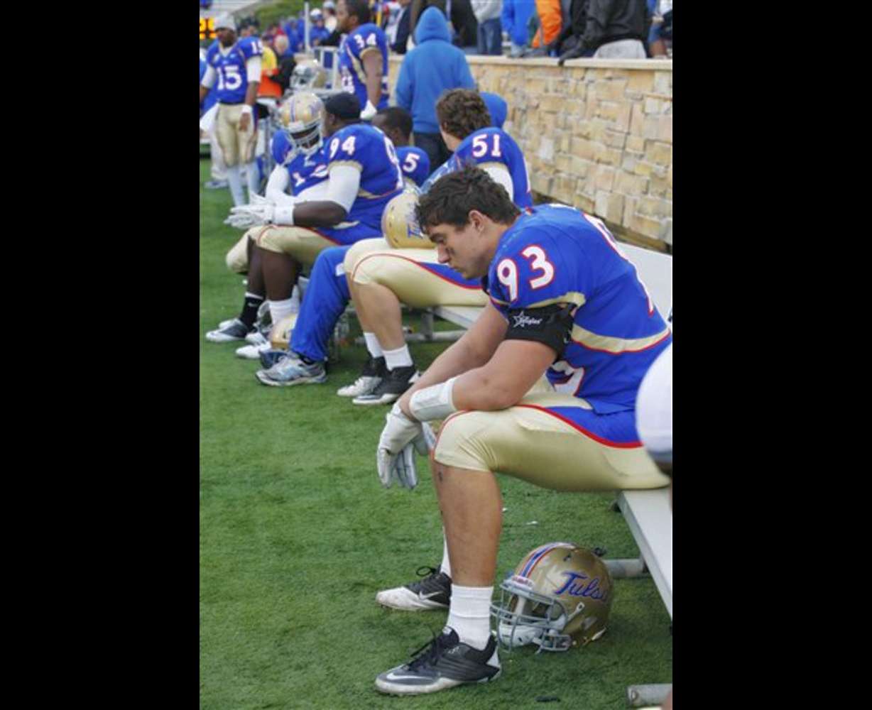 Tulsa defensive end Cory Dorris sits with
teammates on the bench. (AP Photo/Sue Ogrocki)