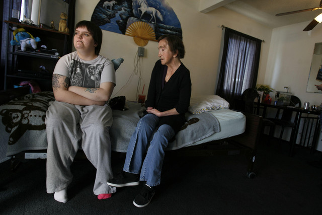 Cortney and Mandi Shaw sit in their living room in Kearns on Friday, Dec. 23, 2011. Shaw is on the verge of losing her home, but a service missionary is trying to prevent that from happening by asking for donations for the Shaws.