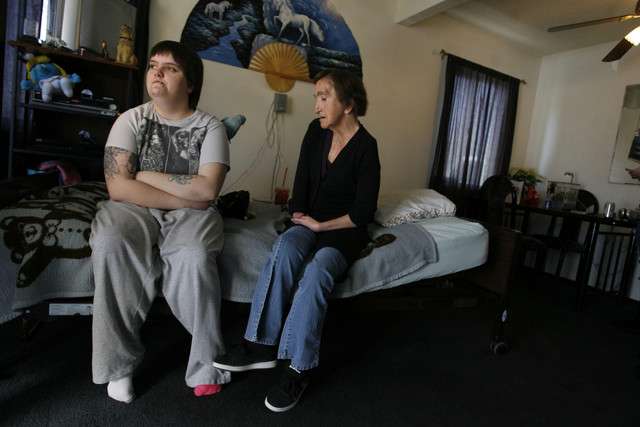 Cortney and Mandi Shaw sit in their living room in Kearns on Friday, Dec. 23, 2011. Shaw is on the verge of losing her home, but a service missionary is trying to prevent that from happening by asking for donations for the Shaws.